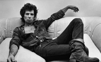 Keith Richards sitting on a couch during a portrait session 